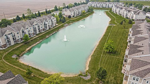 A large pond with fountains in the middle of an apartment development at Tracy Creek Apartments, Perrysburg
