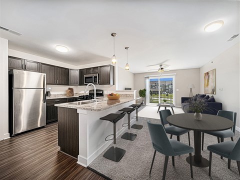 A modern kitchen with a dining table set for four.