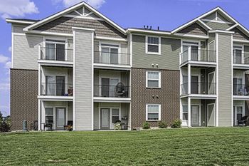 Apartment building with balconies and patios at Trade Winds Apartment Homes in Elkhorn, NE