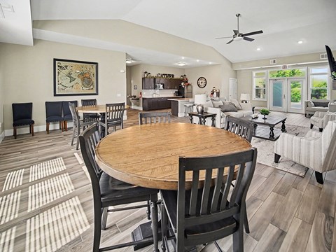 A dining room with a wooden table and chairs at Trade Winds Apartment Homes, Elkhorn, NE, 68022