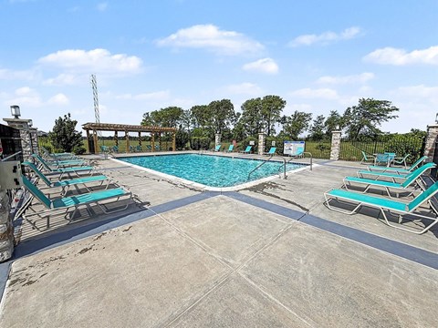 A large outdoor swimming pool with lounge chairs at Trade Winds Apartment Homes, Elkhorn, NE, 68022