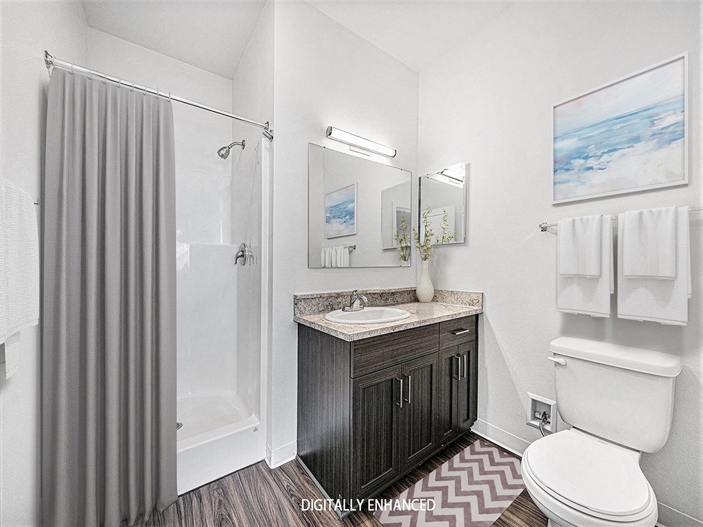 A second bathroom with a sink, toilet, and shower at Trade Winds Apartment Homes, Elkhorn, Nebraska