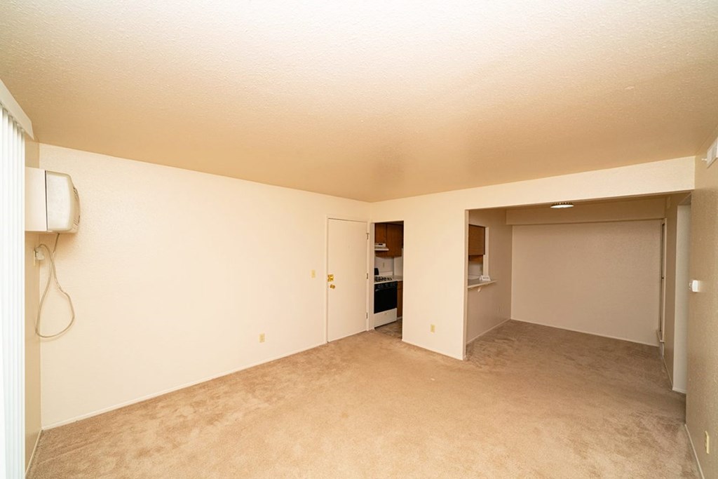 Empty dining room with a breakfast bar and plush carpet at Trappers Cove Apartments, Lansing