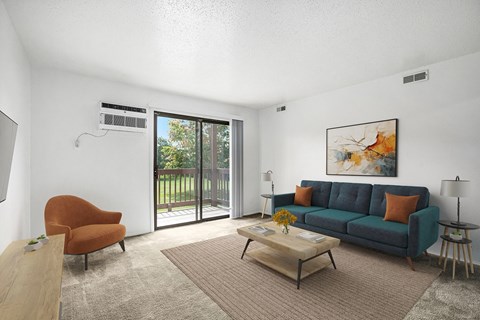 A living room with a blue couch, a chair, a coffee table, and a painting on the wall.