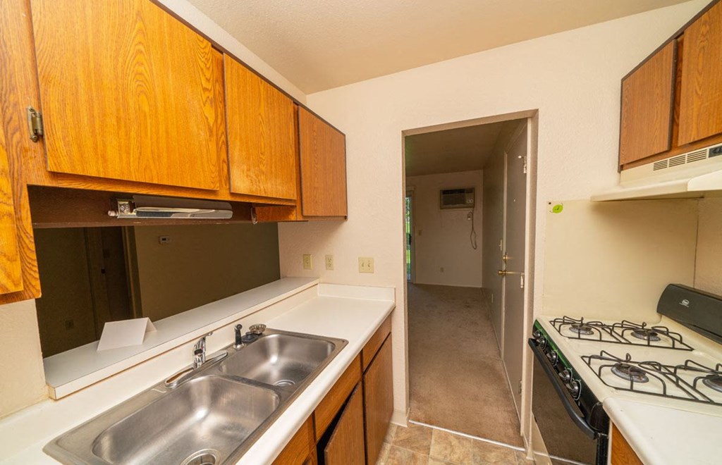 Kitchen leads to Living and Dining Areas at Trappers Cove Apartments, Lansing, MI, 48910