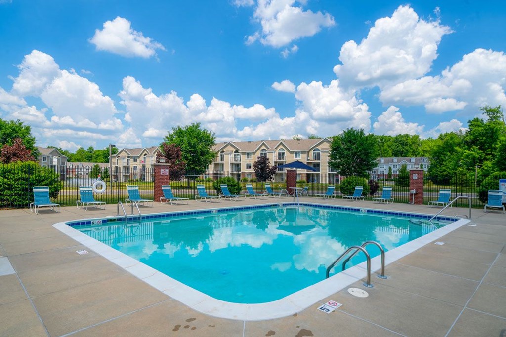 Relaxing Pool Area With Lounge Chairs at Trillium Pointe Apartment Homes, Jackson, Michigan