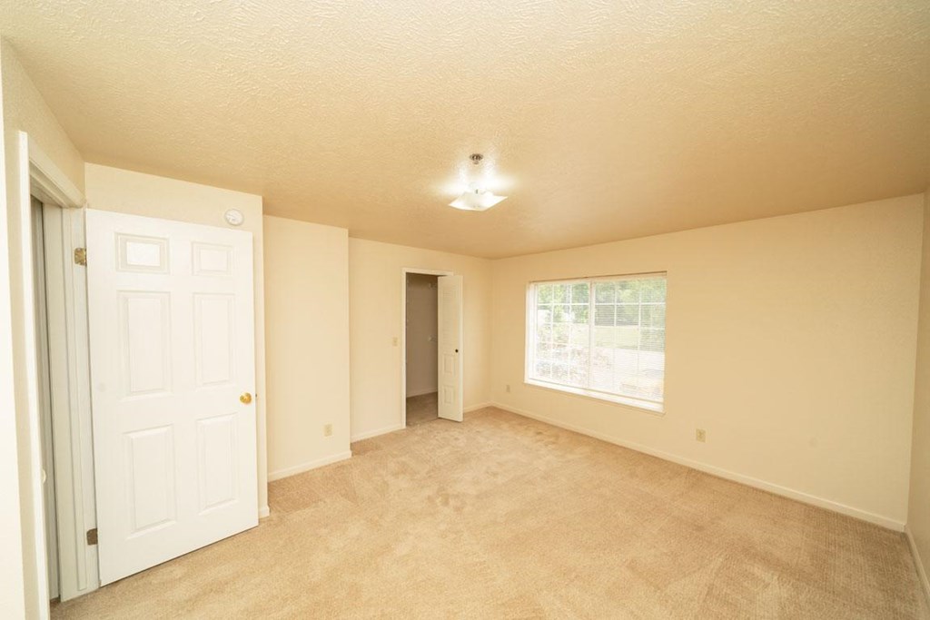 Bedroom with Large Windows at Trillium Pointe Apartment Homes in Jackson, MI