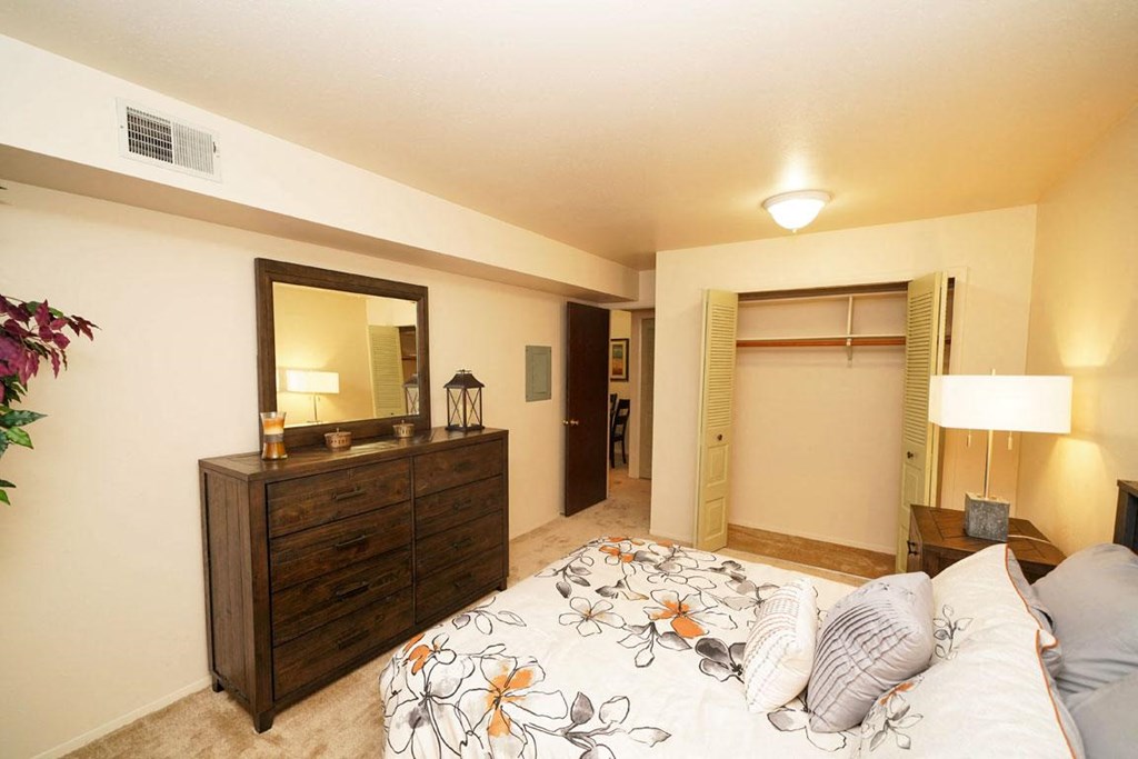 Carpeted Bedroom With Large Closet at Walnut Trail Apartments, Michigan