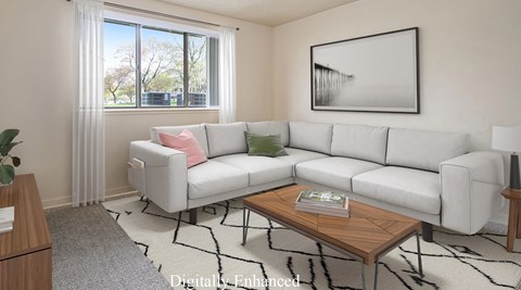 A living room with a white couch and a coffee table.