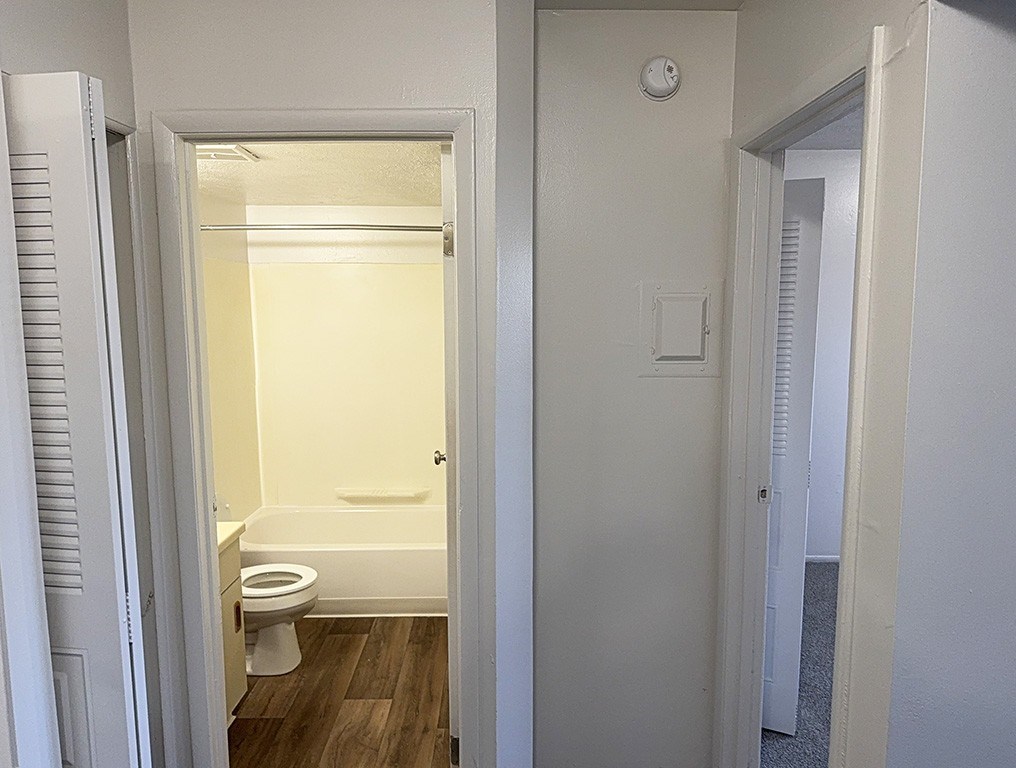 A bathroom with a toilet and a bathtub at Waverly Park Apartments, Lansing