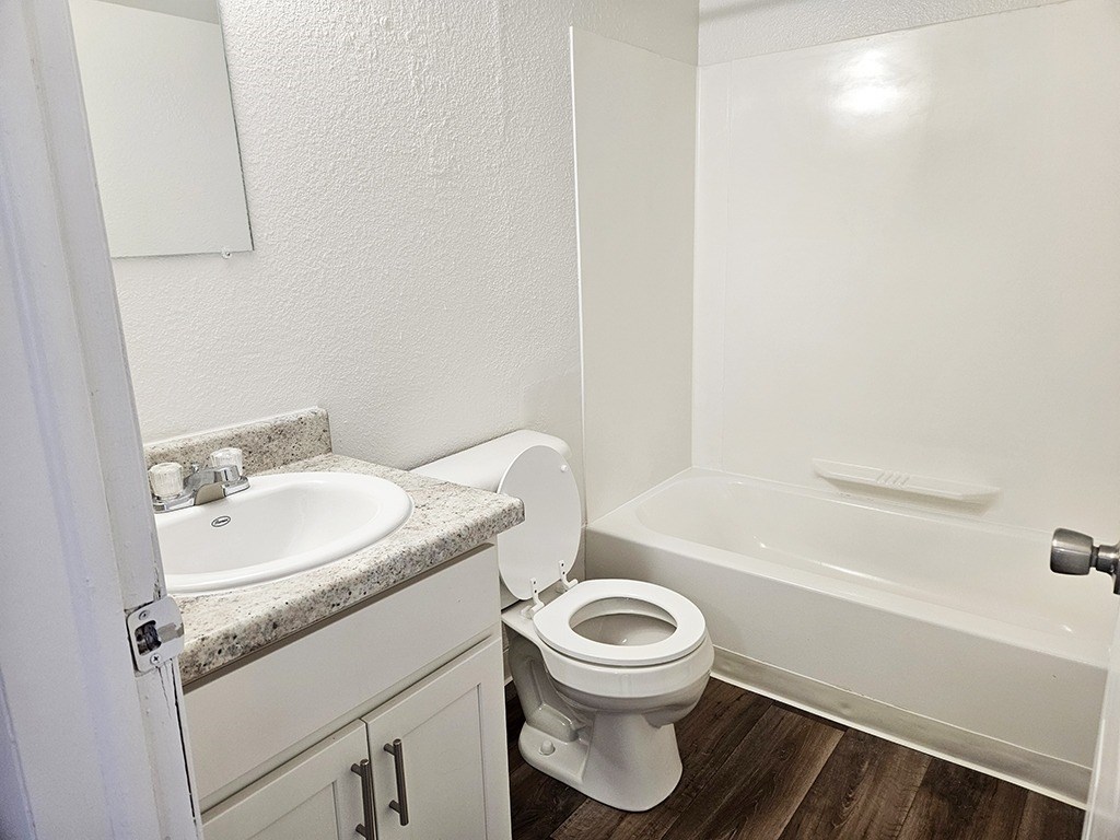 A white toilet sits next to a sink in a small bathroom.