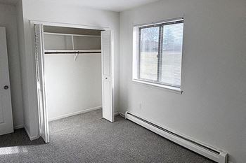 Spacious bedroom with a window and closet at Waverly Park Apartments in Lansing, MI