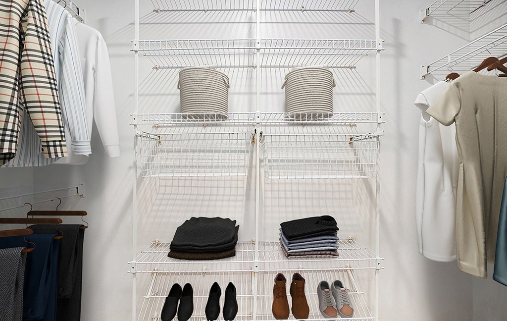 A walk in closet with wardrobe organizers at West Hampton Park Apartments in Elkhorn, NE 68022