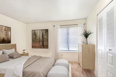 A bedroom with a bed, a nightstand, a cabinet, and a painting on the wall at West Wind Apartments, Fort Wayne, 46808