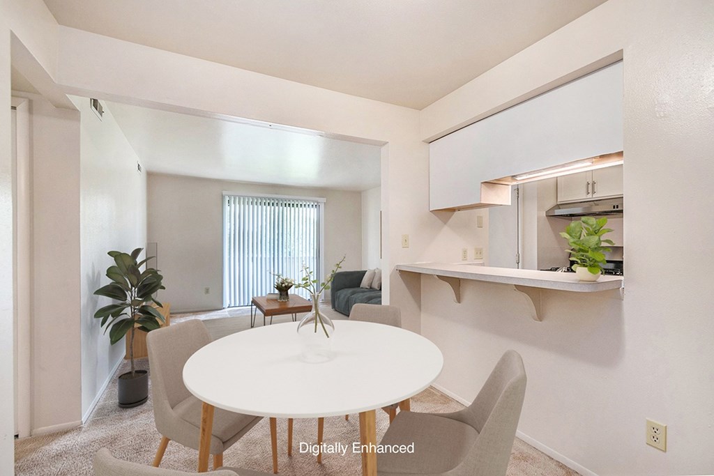 A dining room with a white table and chairs A dining room with a white table and chairs at West Wind Apartments, Fort Wayne, 46808