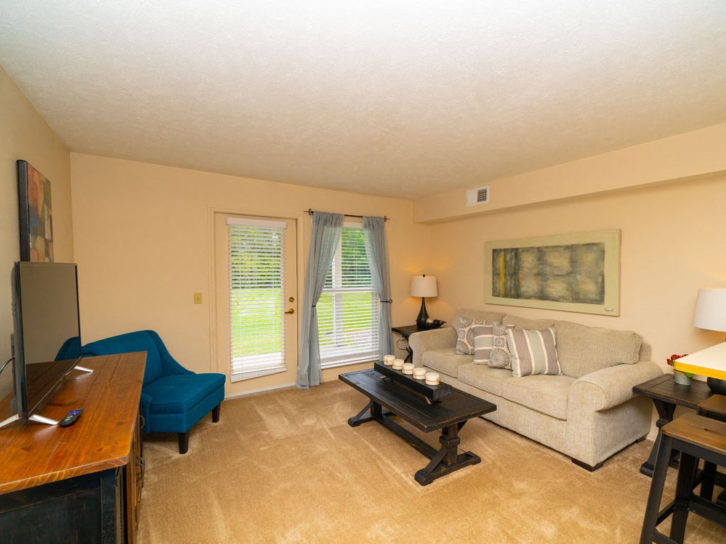 Classic Living Room Design With French Door to Private Patio at West Hampton Park Apartment Homes, Elkhorn