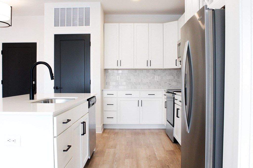 a kitchen with white cabinets and stainless steel appliances  at Avant & Avant II, Carmel, Indiana