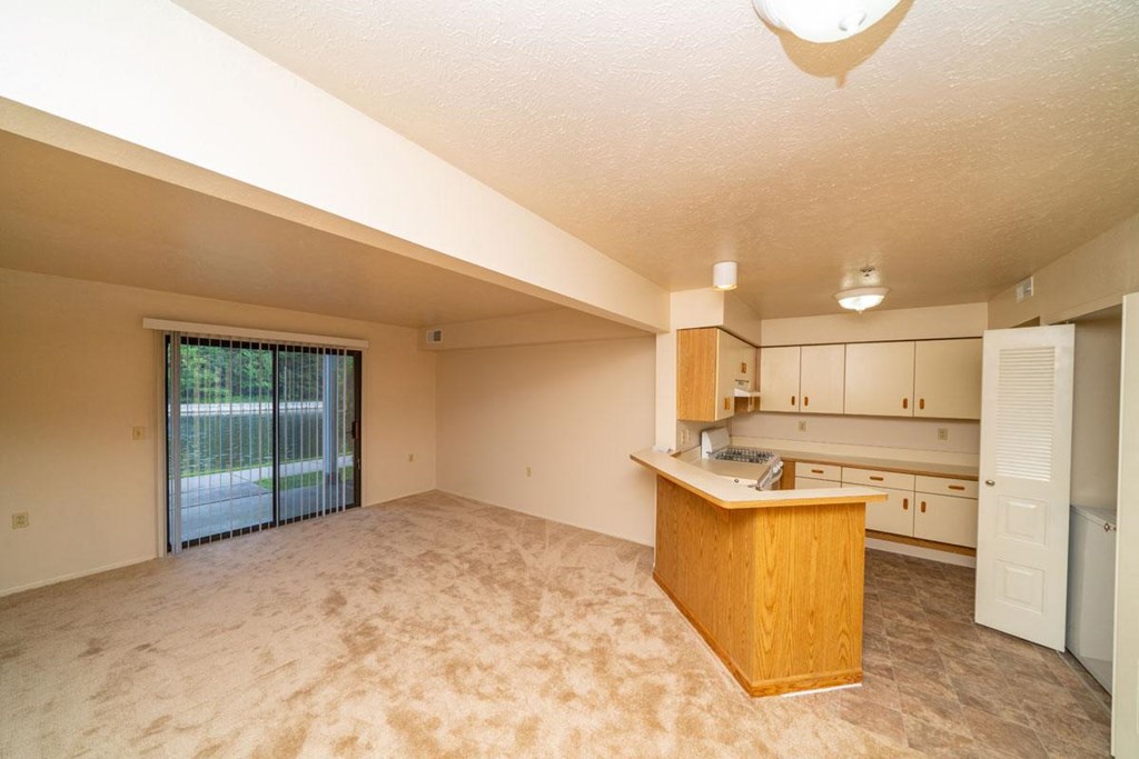 Living Room with Slider to Patio at Windmill Lakes Apartments, Holland, 49424