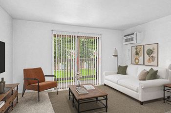 A living room with a white couch, and a slider to a private balcony at Wingate Apartments, Michigan, 49512