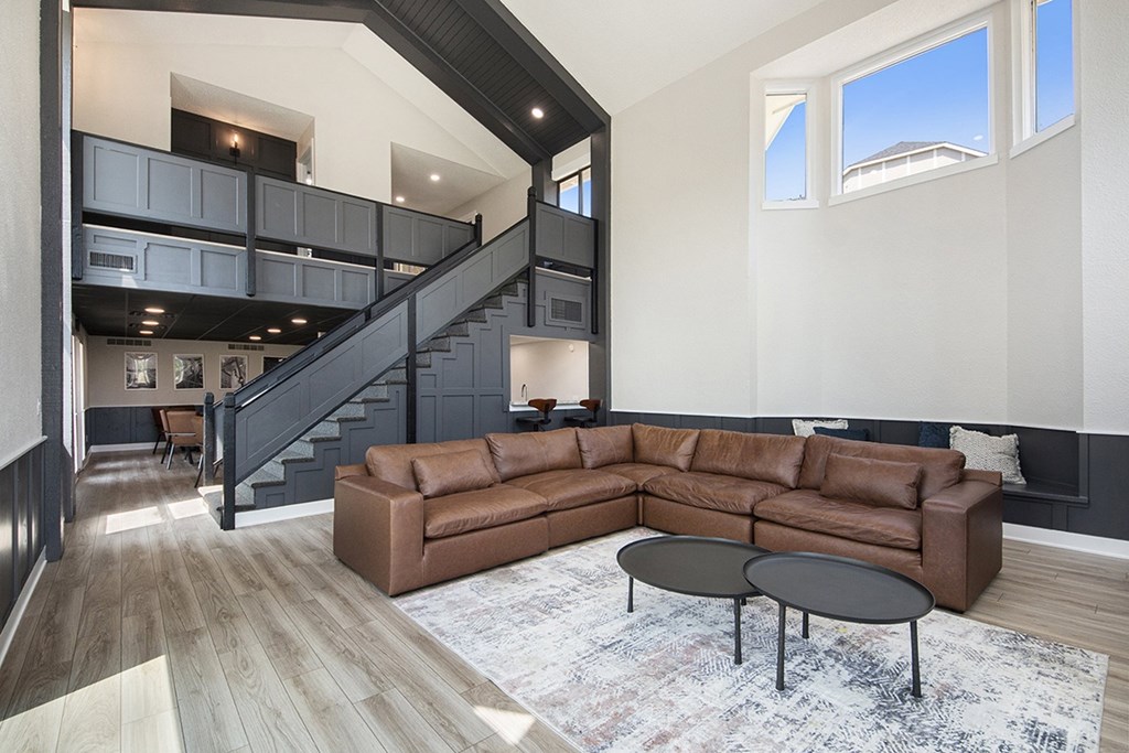 A community room with a brown couch and a black coffee table at Wingate Apartments, Kentwood