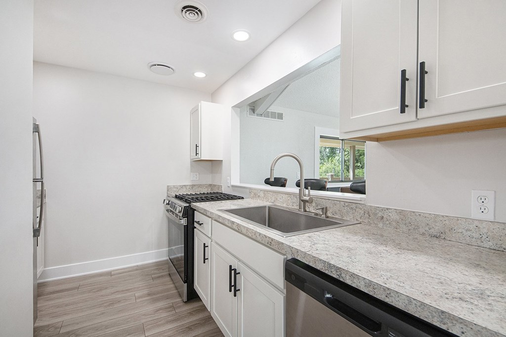 A modern kitchen with stainless steel appliances at Wingate Apartments, Kentwood