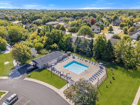 A bird's eye view of an apartment community with a swimming pool at Wood Creek Apartments, Wisconsin
