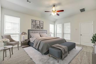 a bedroom with a large bed and a ceiling fan - Photo Gallery 4