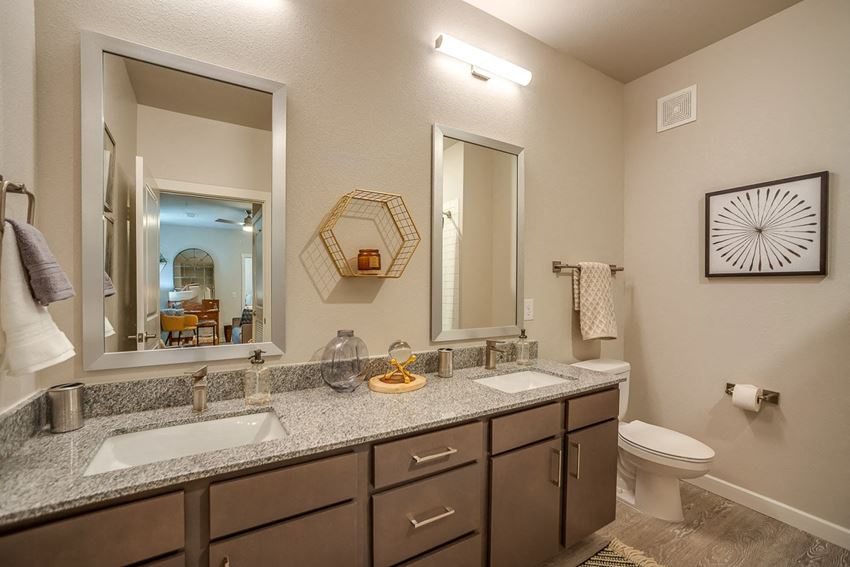 Apartment Bathroom with Double Vanity Sinks a bathroom with two sinks and a toilet