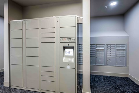 A large, grey locker room with a sign that says "Locker Room".