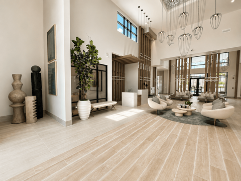 A spacious living room with a large rug and a long table.
