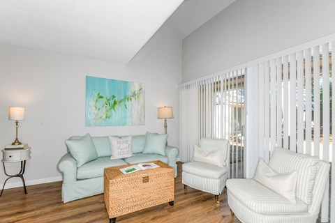 a living room with a couch and two chairs