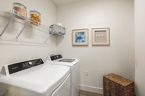 A white washing machine and dryer in a small laundry room.