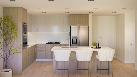 A modern kitchen with white chairs and wooden cabinets.