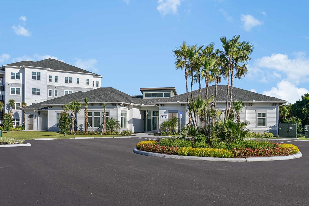 a large house with palm trees in front of it