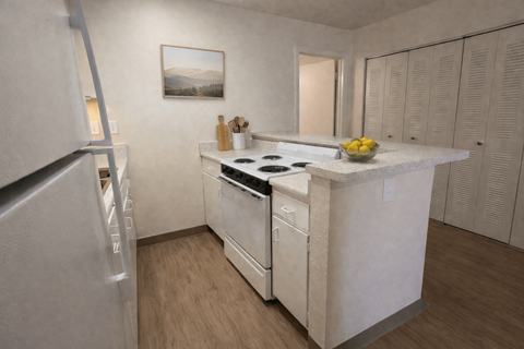 A kitchen with a white counter top and a fridge on the left.