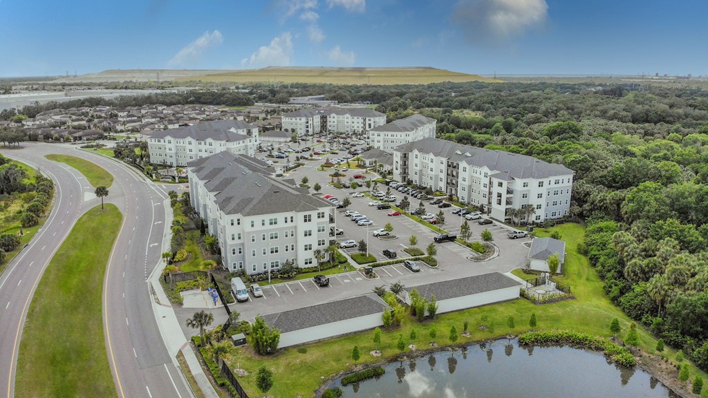 an aerial view of a city with buildings and a lake