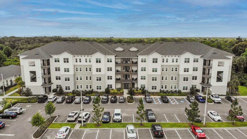 an aerial view of an apartment building in a parking lot