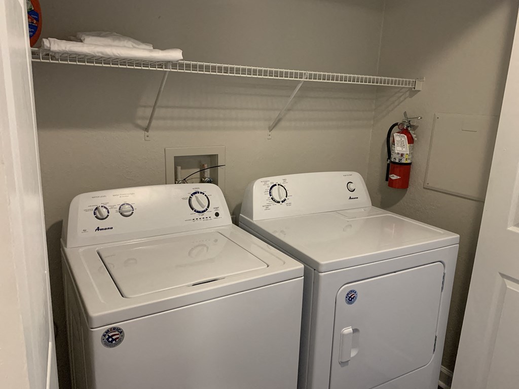 full size washer and dryer with shelf above