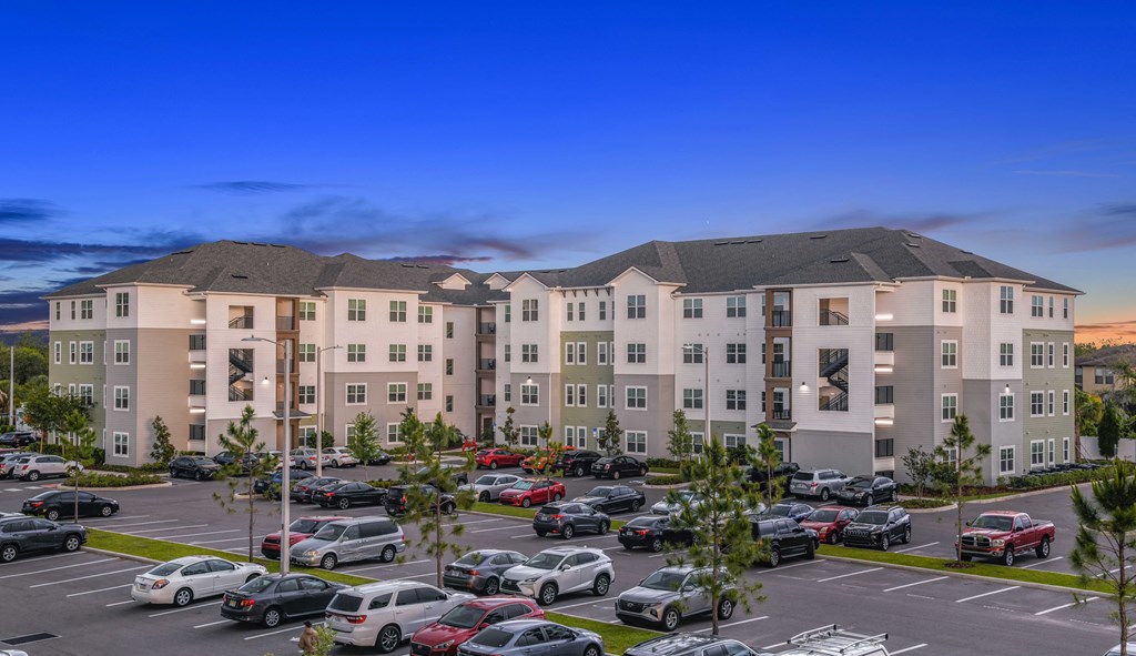 an aerial view of an apartment complex with a parking lot