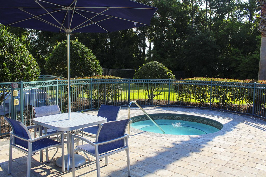 Hot tub and table with umbrella and chairs