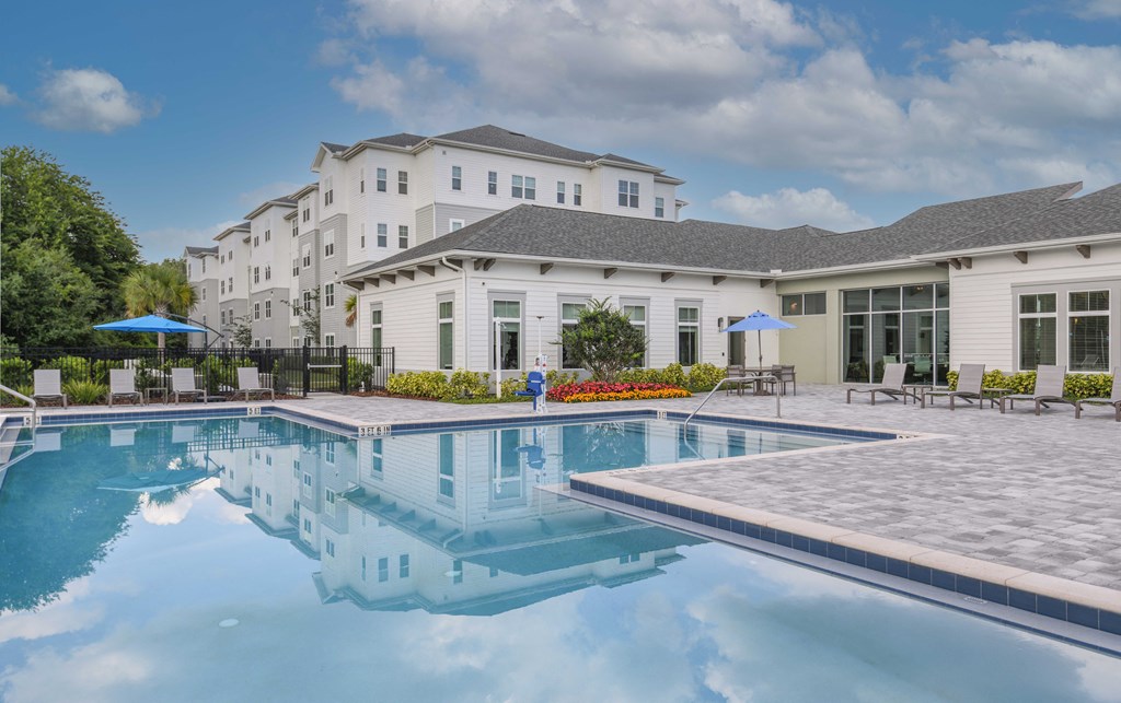 a swimming pool with a building in the background