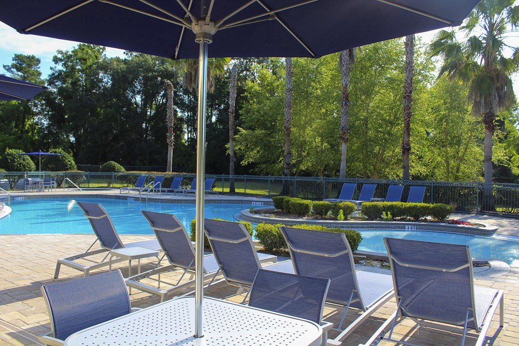 Chairs and umbrella poolside