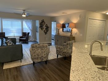 Kitchen bar, living room and large window with blinds