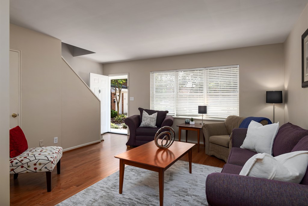 A living room with a couch, chair, and table.