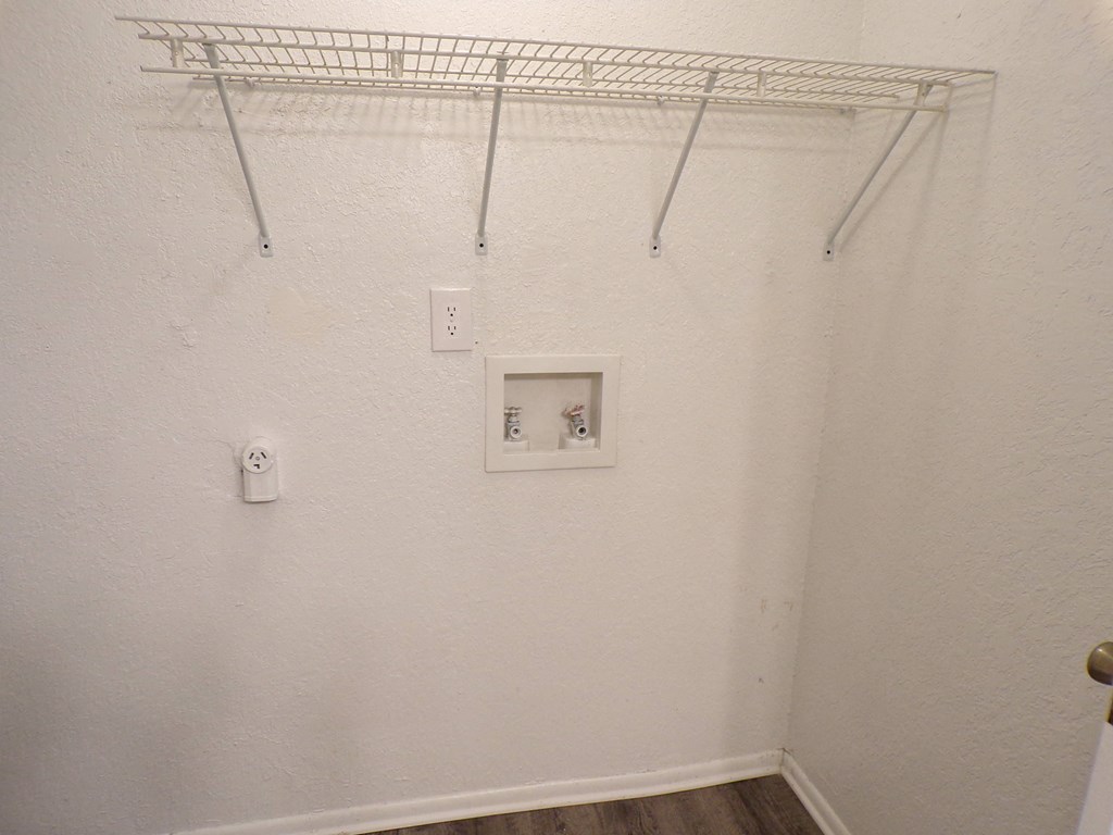 an empty closet with a wire rack on the wall