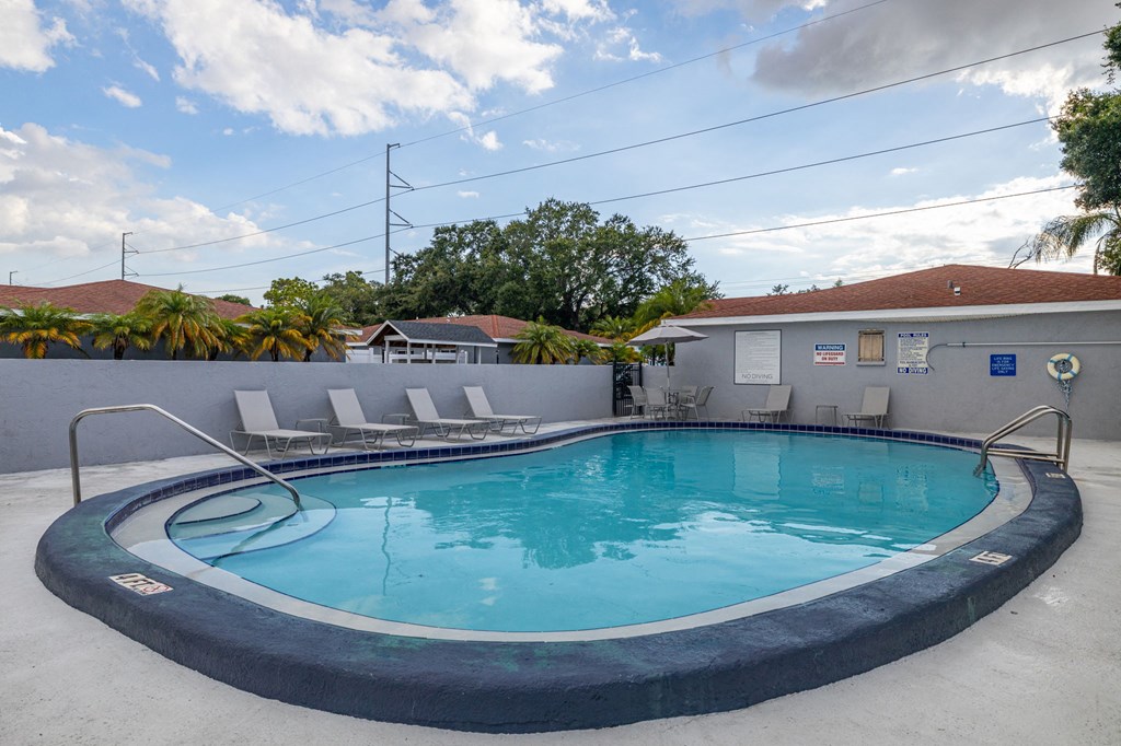 a swimming pool with a house in the background