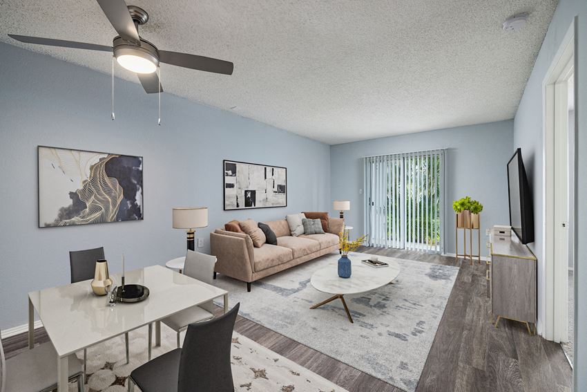 a living and dining room with a couch table and chairs and a tv on the wall - Photo Gallery