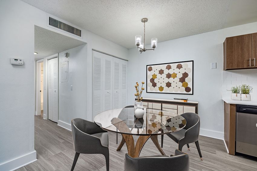 a dining area with a glass table and four chairs - Photo Gallery