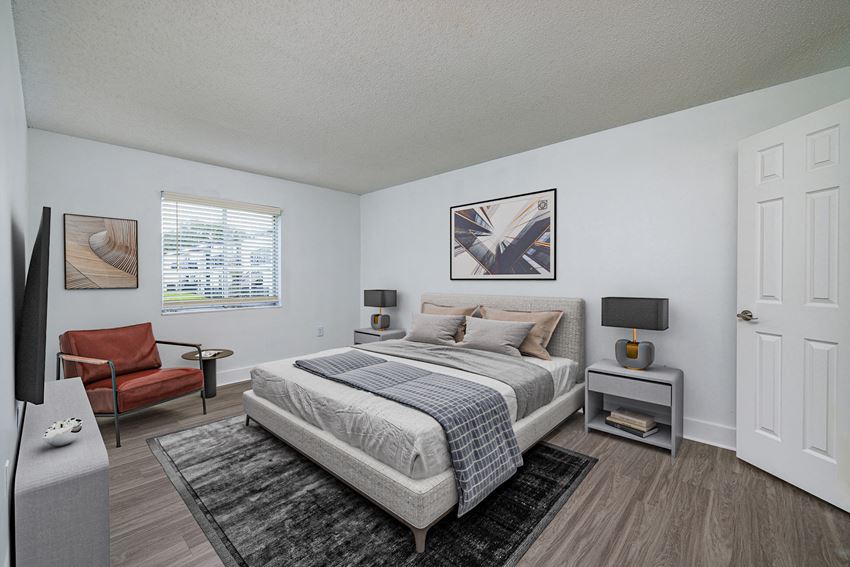a bedroom with a bed and chair - Photo Gallery