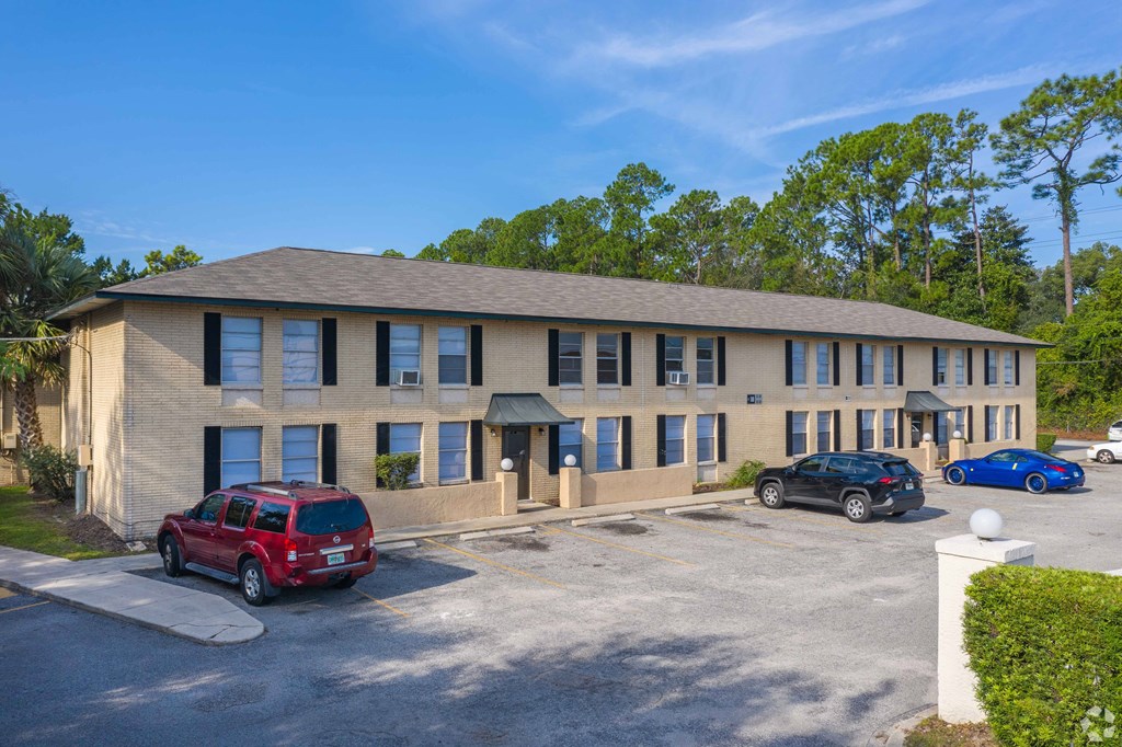 A building with a parking lot in front of it.